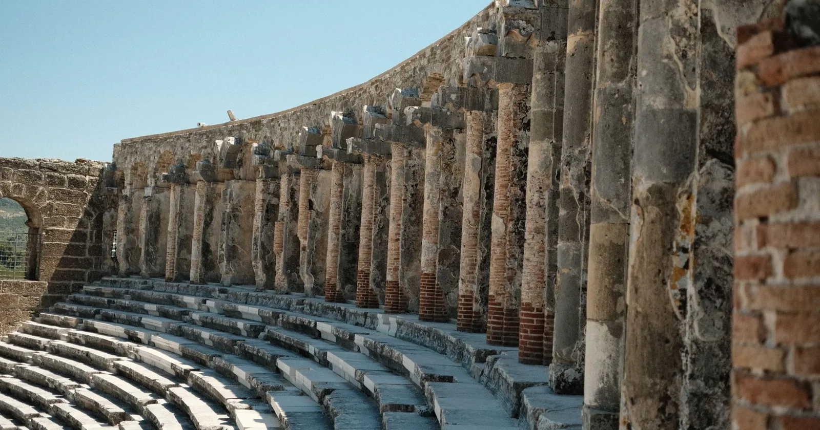 Tiered stone seating and colonnade of a Roman theatre
