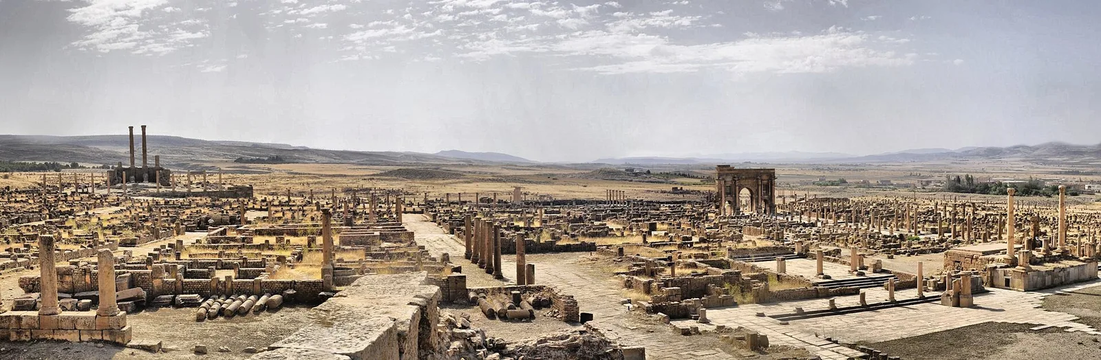 Colonnaded streets and arch in the ruins of Timgad