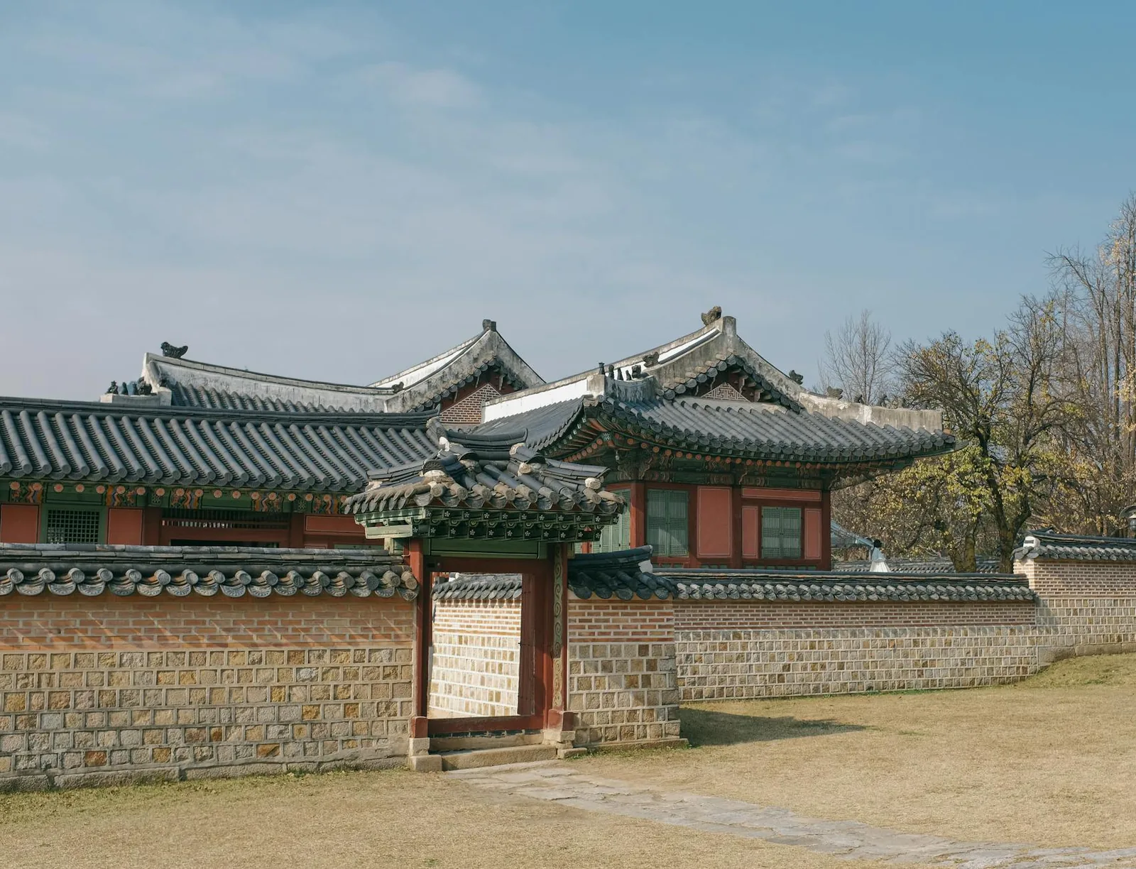 The stone courtyard and tiled halls of Gyeongbokgung Palace in Seoul.